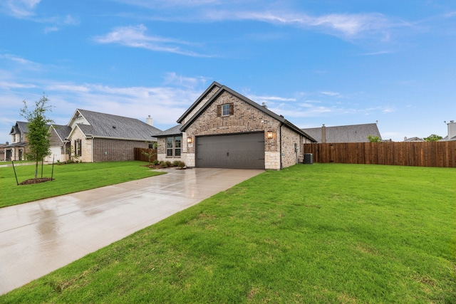 view of front of property featuring cooling unit, concrete driveway, a front yard, an attached garage, and fence