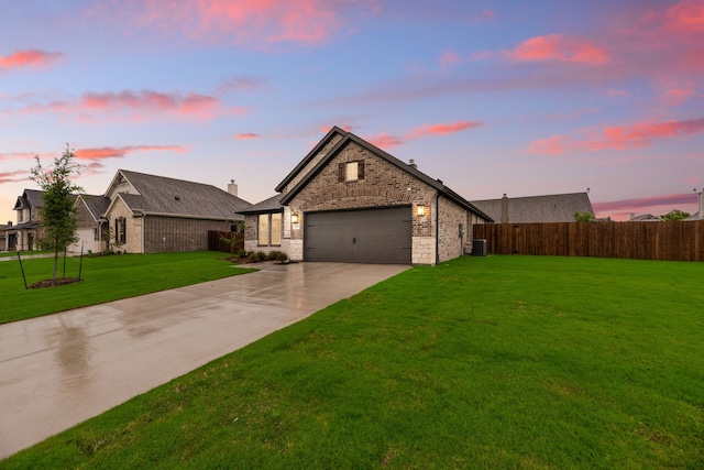 view of front of property with a front yard, a garage, cooling unit, driveway, and fence