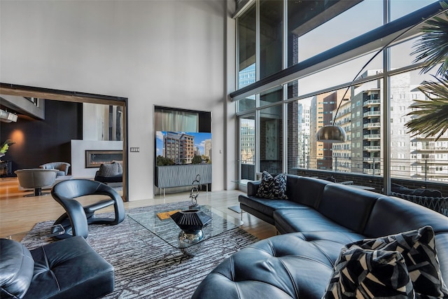 living room featuring hardwood / wood-style flooring and a high ceiling