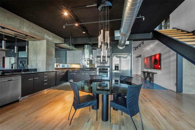 dining room with light hardwood / wood-style floors and sink