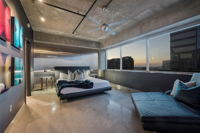 bedroom with ceiling fan and concrete floors