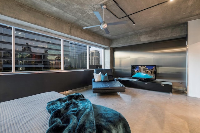 bedroom featuring ceiling fan and concrete floors