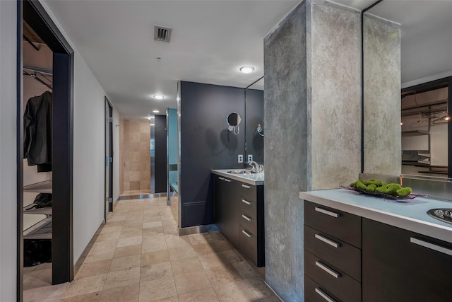 bathroom featuring vanity and a shower with door