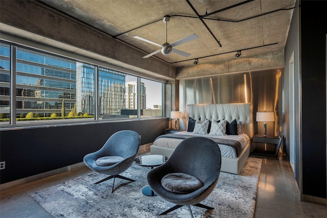 bedroom featuring ceiling fan and concrete flooring