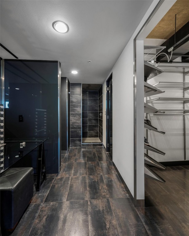 corridor with dark hardwood / wood-style flooring