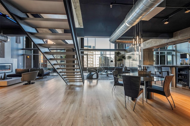 2011 Cedar Springs Rd Unit 606, Dallas, TX 75201 - dining area featuring plenty of natural light, wood finished floors, a wall of windows, a glass covered fireplace, and track lighting