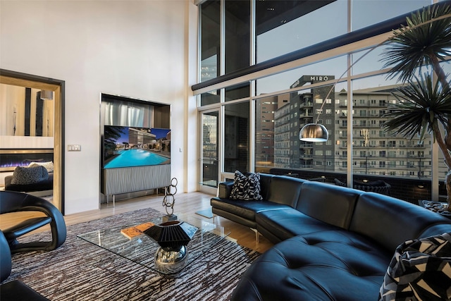 living room featuring hardwood / wood-style floors and a towering ceiling