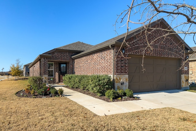 view of front of property with a garage and a front yard