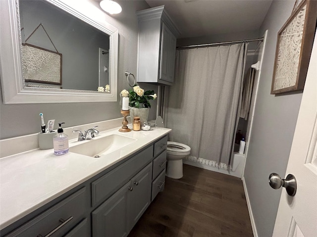 full bathroom with hardwood / wood-style flooring, vanity, toilet, and shower / bath combo