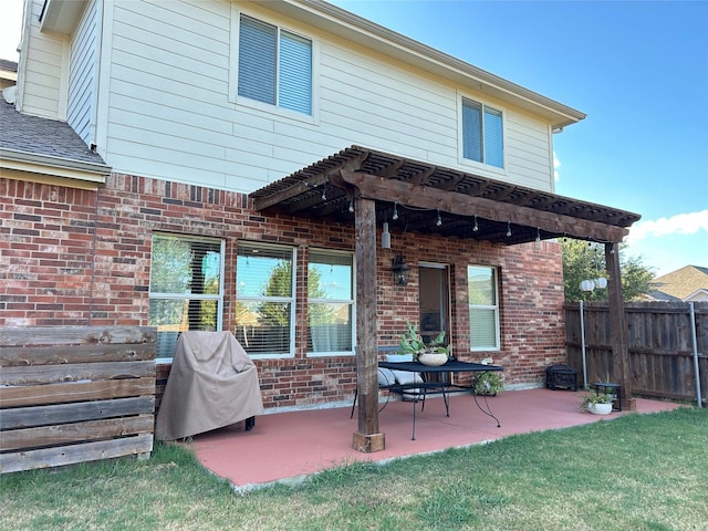 back of property featuring a patio and a yard