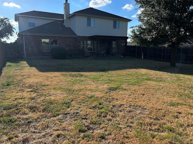 back of house featuring a yard