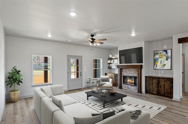 316 Clubview Dr, Bowie, TX 76230 - living room featuring a ceiling fan, a brick fireplace, visible vents, light wood-style floors, and recessed lighting