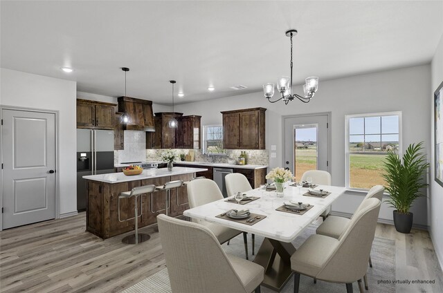 316 Clubview Dr, Bowie, TX 76230 - dining area featuring recessed lighting, visible vents, light wood-style flooring, and a notable chandelier