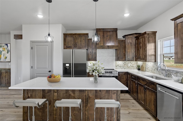 316 Clubview Dr, Bowie, TX 76230 - kitchen featuring a sink, light wood-type flooring, light countertops, dark brown cabinets, and appliances with stainless steel finishes