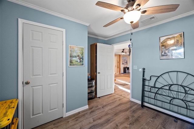 bedroom featuring crown molding, ceiling fan, and hardwood / wood-style flooring