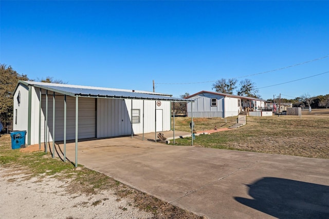 exterior space with a carport, an outbuilding, and a yard