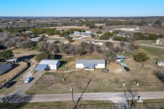 view of side of home featuring a yard and an outbuilding