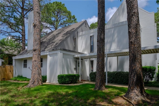 rear view of property with a yard