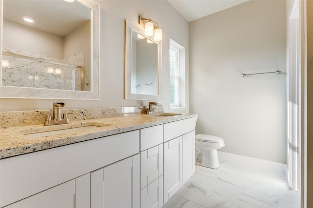 bathroom featuring vanity, an enclosed shower, and toilet