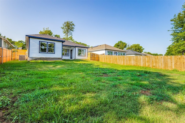 exterior space featuring cooling unit and a lawn