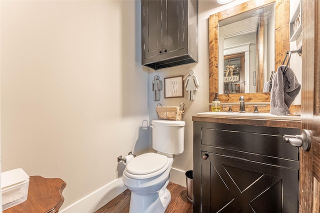 bathroom with vanity, wood-type flooring, and toilet