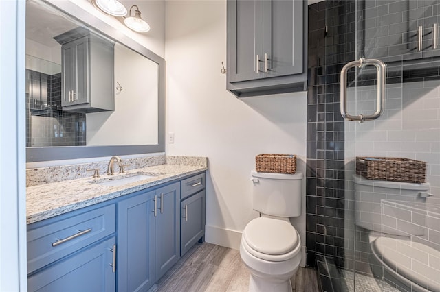 bathroom featuring hardwood / wood-style floors, vanity, and toilet