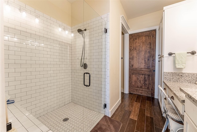 bathroom featuring vanity and a shower with shower door