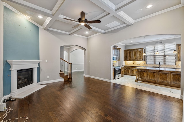 living room with beamed ceiling, light hardwood / wood-style floors, and coffered ceiling