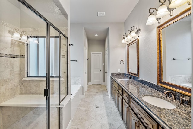 bathroom featuring vanity and independent shower and bath