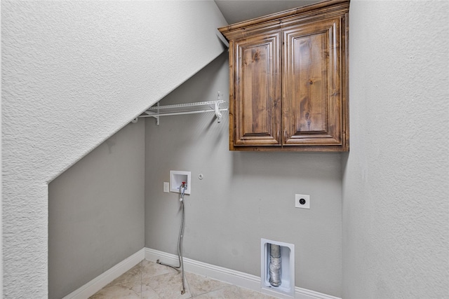 clothes washing area with cabinets, washer hookup, electric dryer hookup, light tile patterned floors, and hookup for a gas dryer