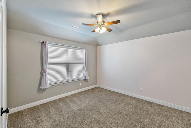 carpeted spare room featuring ceiling fan and lofted ceiling