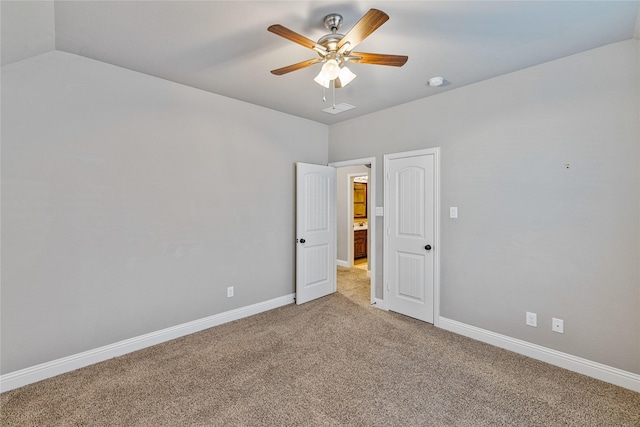 empty room featuring ceiling fan, carpet floors, and vaulted ceiling