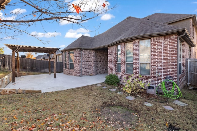 back of house with a pergola and a patio