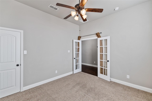 carpeted spare room with french doors and ceiling fan