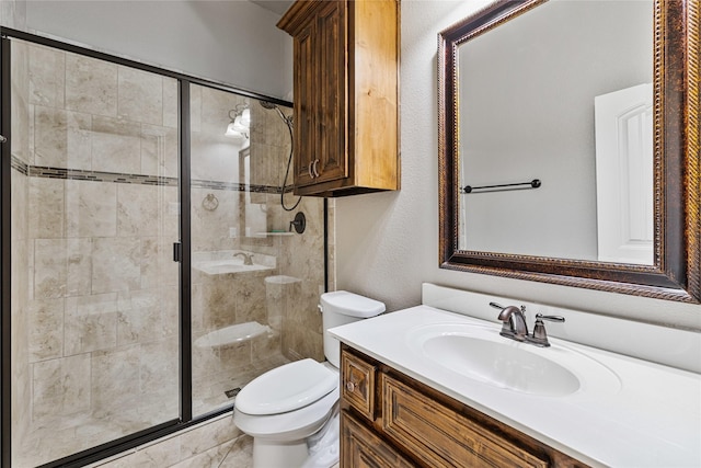 bathroom with vanity, an enclosed shower, and toilet