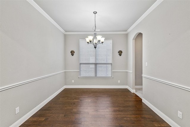 unfurnished dining area featuring dark wood-type flooring, a chandelier, and ornamental molding