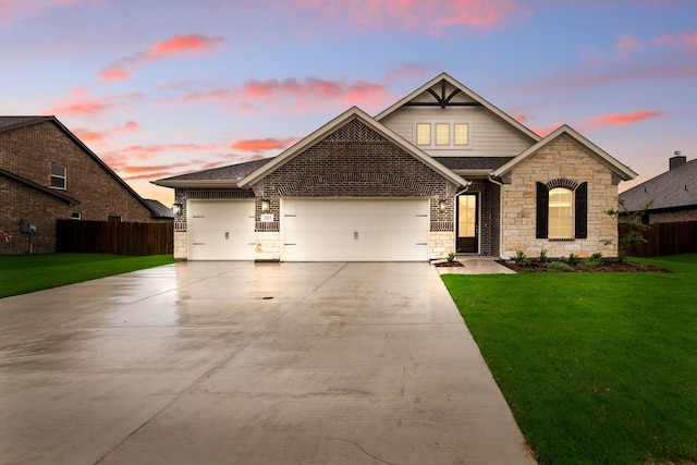 view of front of property featuring fence, a lawn, and stone siding