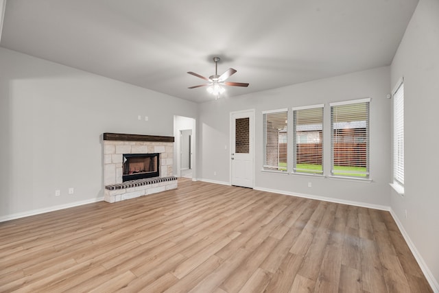 unfurnished living room featuring light wood-type flooring, a ceiling fan, and a healthy amount of sunlight