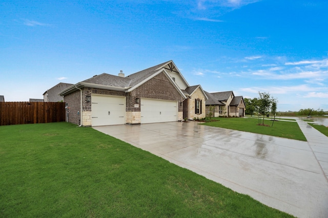 view of front of house with driveway, a shingled roof, a front yard, an attached garage, and fence