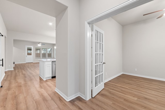 hall with baseboards, recessed lighting, and light wood-style flooring