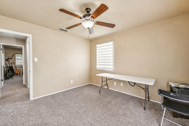 misc room with carpet flooring and ceiling fan