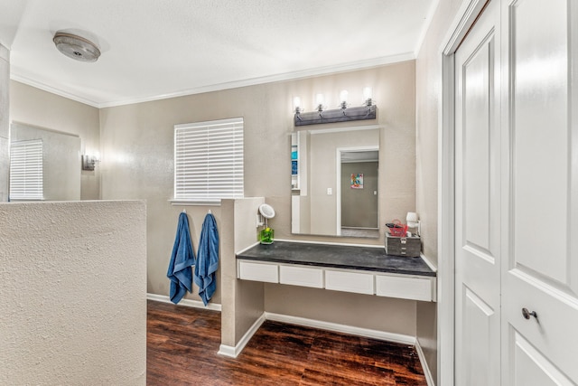 bathroom featuring wood-type flooring, vanity, and crown molding