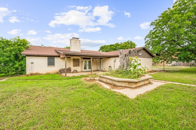 back of property featuring a lawn