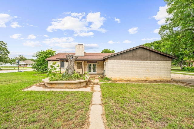 ranch-style house with french doors and a front yard