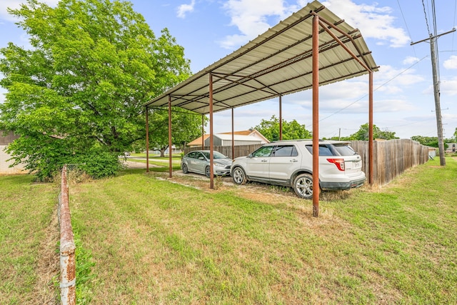 view of parking with a yard and a carport