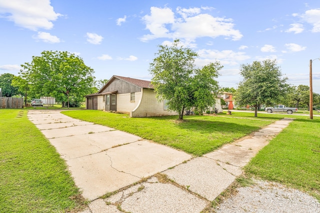 view of side of home with a yard