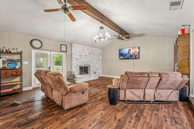 living room featuring a textured ceiling, vaulted ceiling with beams, a stone fireplace, and dark wood-type flooring