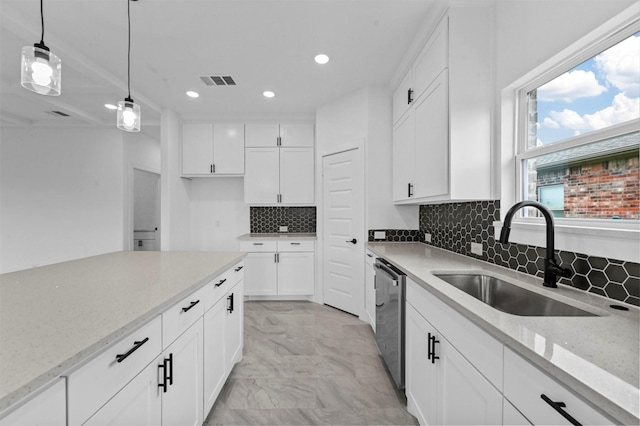 kitchen featuring dishwasher, hanging light fixtures, sink, white cabinetry, and light stone countertops