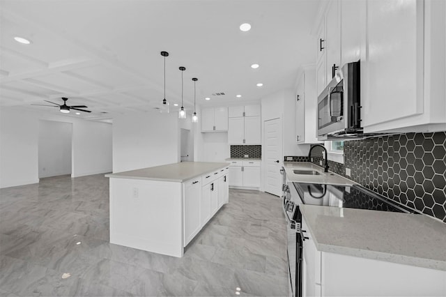 kitchen featuring white cabinetry, a center island, and stainless steel appliances