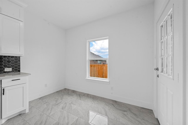 unfurnished dining area with plenty of natural light